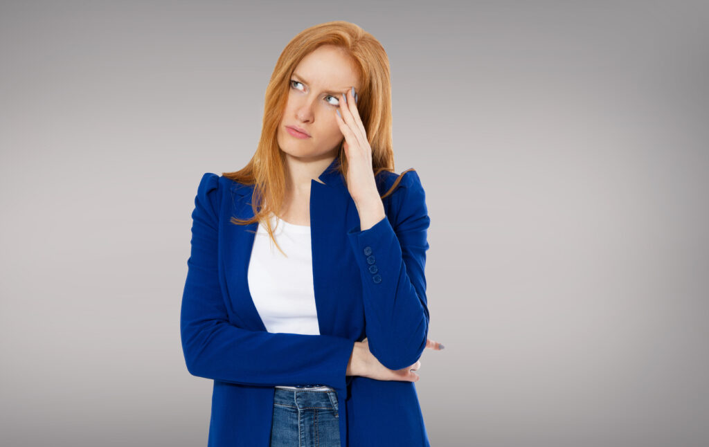 woman head pain, female migraine, unhappy young adult female wearing blouse, hitting her head, eyes closed, gesturing she has made a big mistake hard work tired